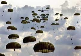 A group of parachutes flying in the sky.